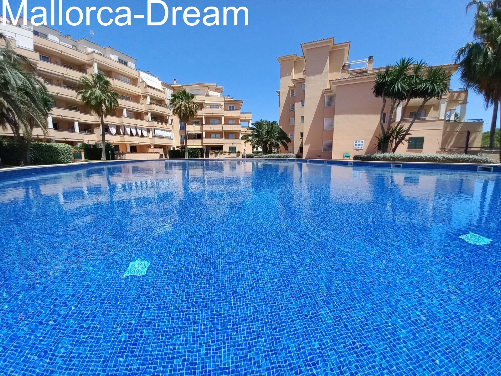 Sa Coma:  Modernized ground floor apartment with approx. 60 m² terraces, fantastic pool area, underground parking space & storage room 